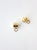 Two gold cylindrical charms with loops on a white background